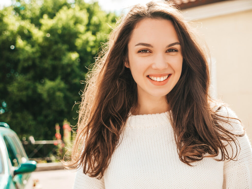 Closeup portrait beautiful smiling brunette model trendy female posing street