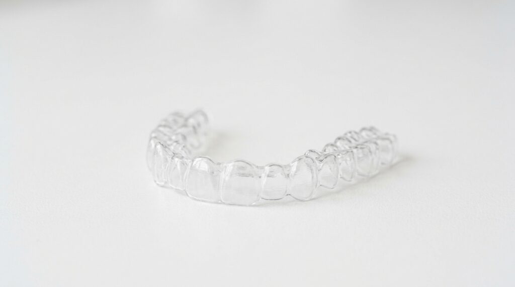 Plastic dental aligner on surface fb531370bb